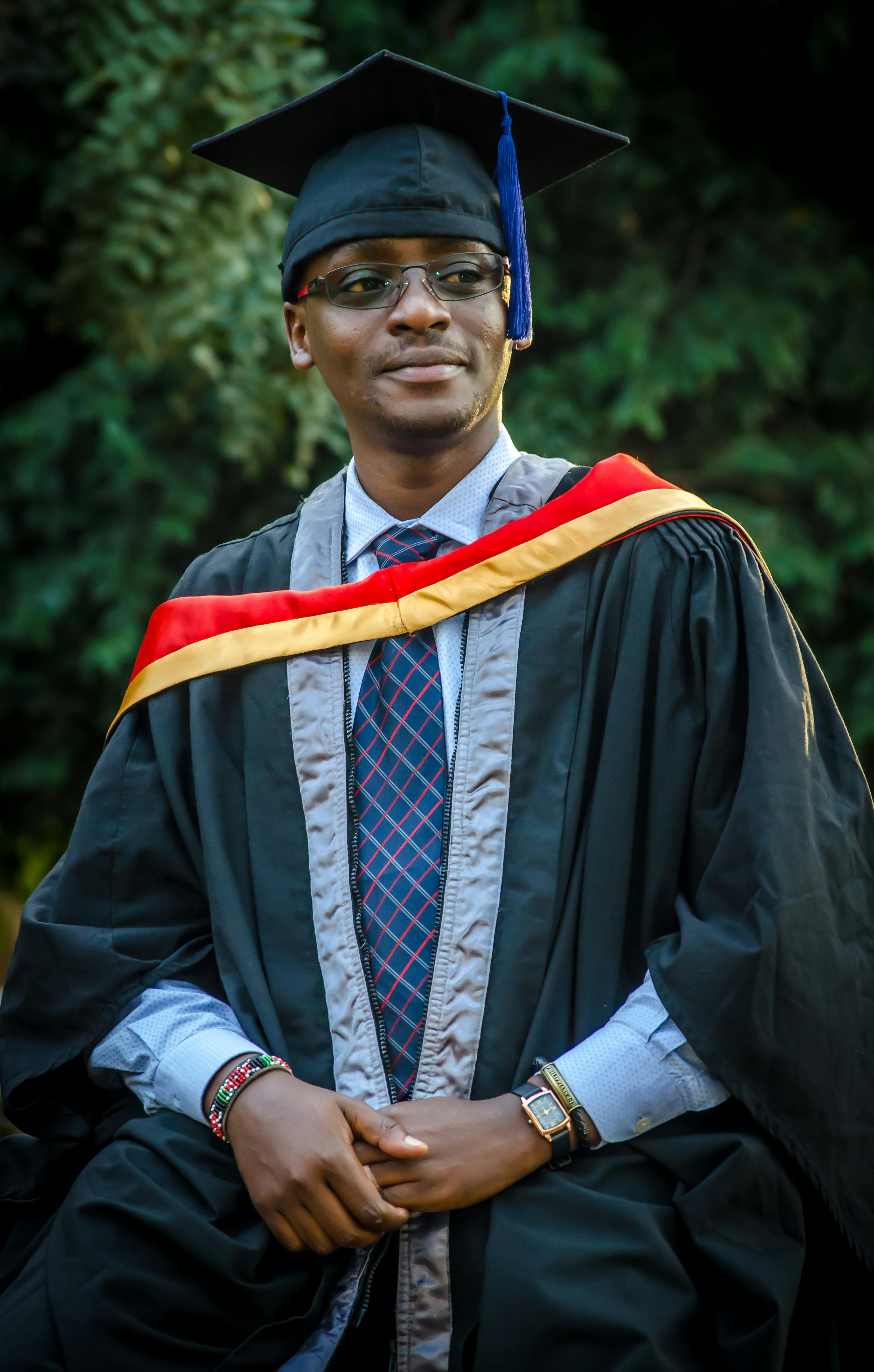 Black Man In A Graduation Gown Smiles Background, Graduation Picture Ideas  In Cap And Gown For Guys, Education, Graduation Background Image And  Wallpaper for Free Download